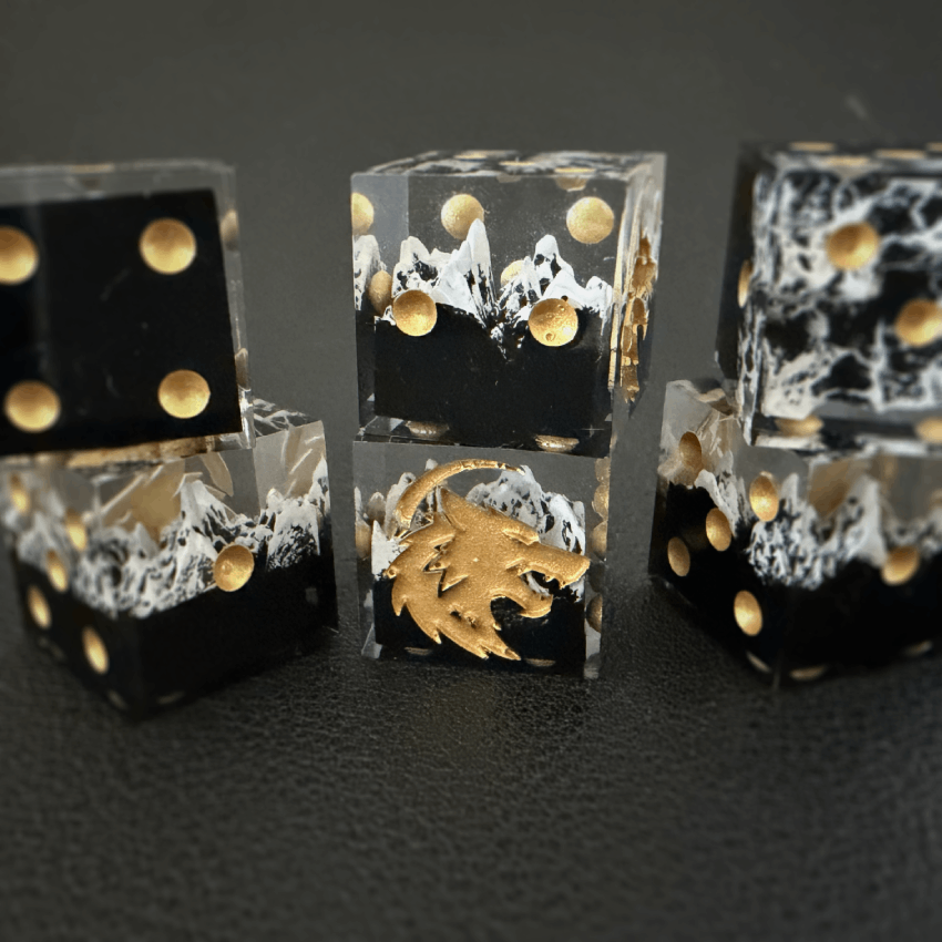 Six mountain dice stacked against a black background