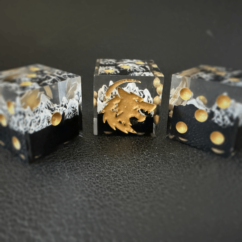 Three mountain dice arrayed horizontally against a black background