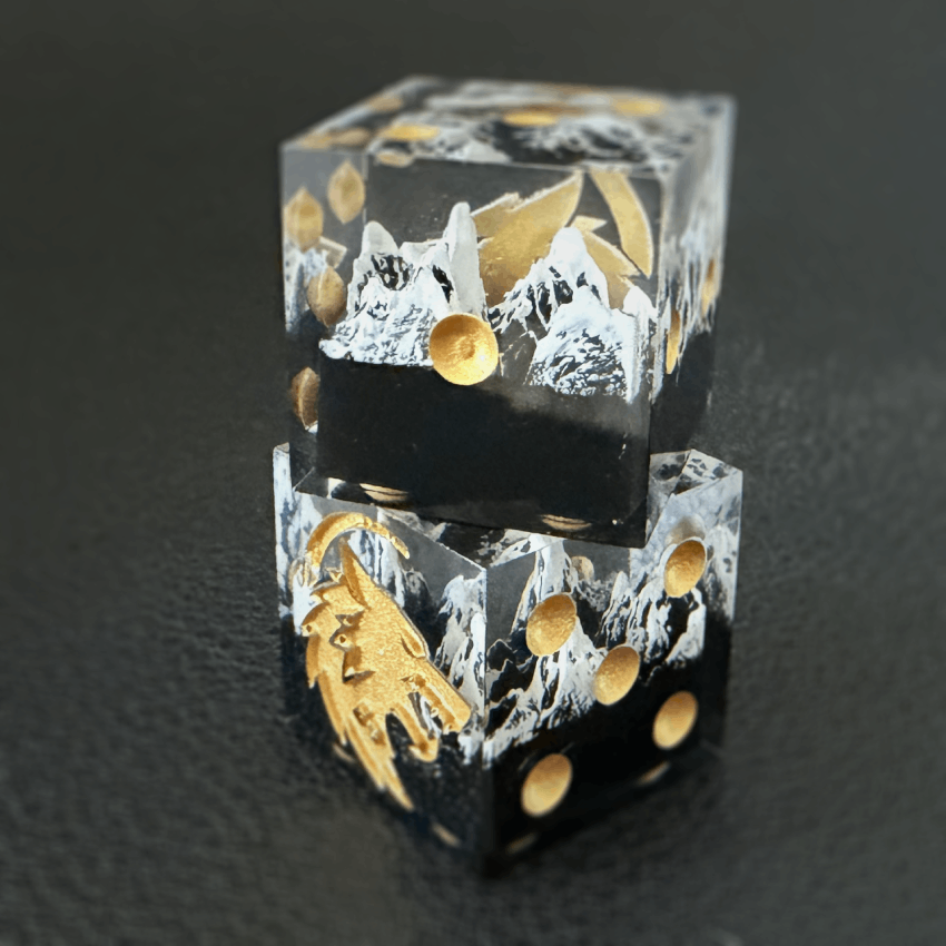 Two mountain dice stacked against a black background